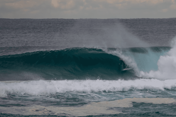 Ethan Ewing surfs overhead wave on North Stradbroke Island