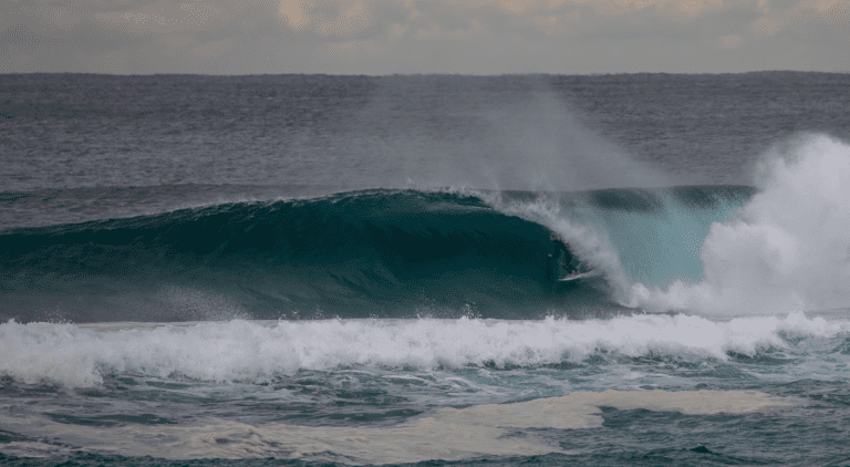 Ethan Ewing surfs overhead wave on North Stradbroke Island