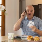 Man eating breakfast with ticket