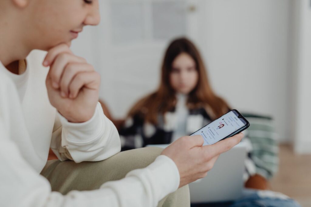 Photo by https://kaboompics.com/: https://www.pexels.com/photo/hands-of-a-boy-using-a-smart-phone-6255940/